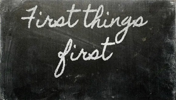 Chalkboard that reads first things first, to help inspire others to manage time and energy better.