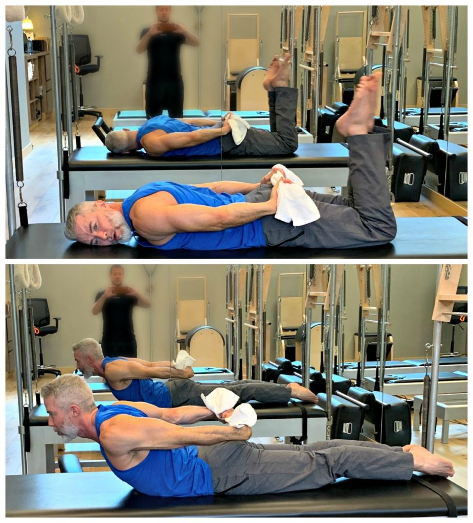 Mature male athlete doing chest opener stretch using towel. 