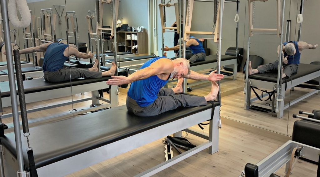Dane Findley demonstrates the Saw Exercise in pilates mat work.