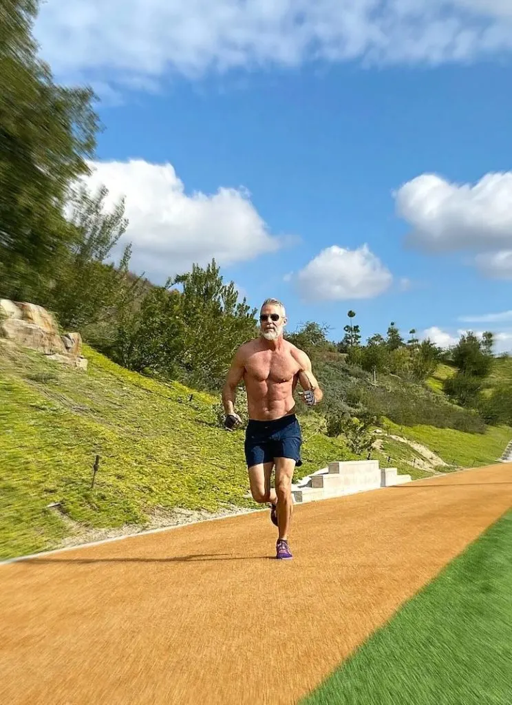 mature man running outdoors for Leg Day training to warm-up legs.