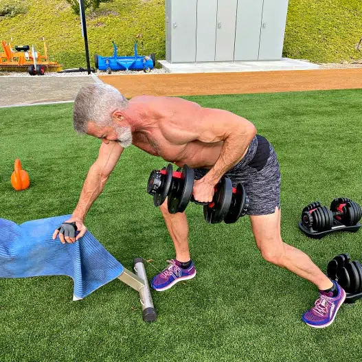 Silver-haired athlete does lower lat exercises.