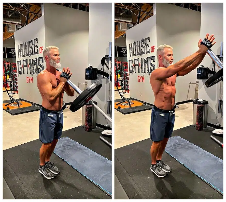 Athlete demonstrates landmine shoulder chest press exercise with a leaning barbell.