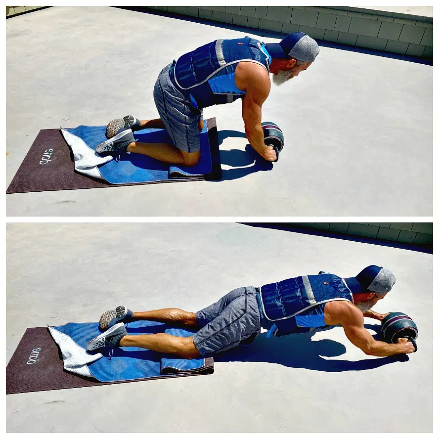 Athlete, age 54, does ab roller exercise in weighted vest.