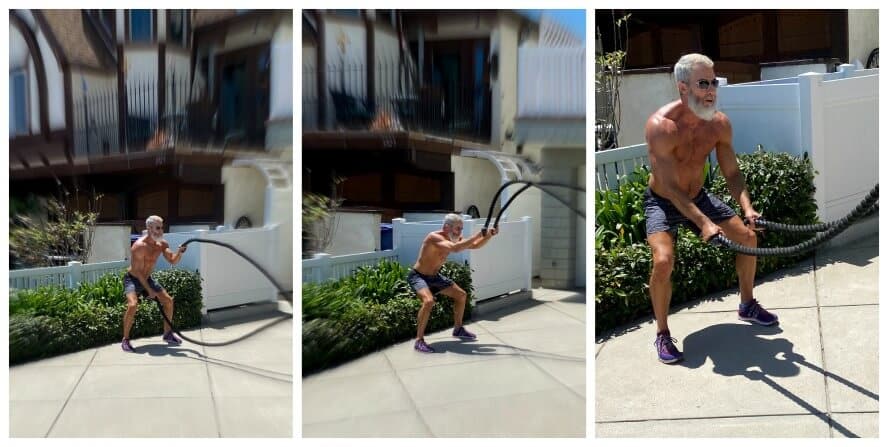 Older athlete does battle rope in his driveway.