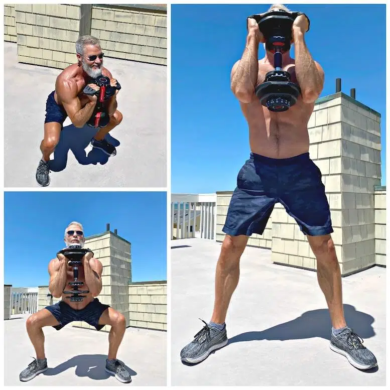 Man strengthens his thighs and booty doing front squat variation.