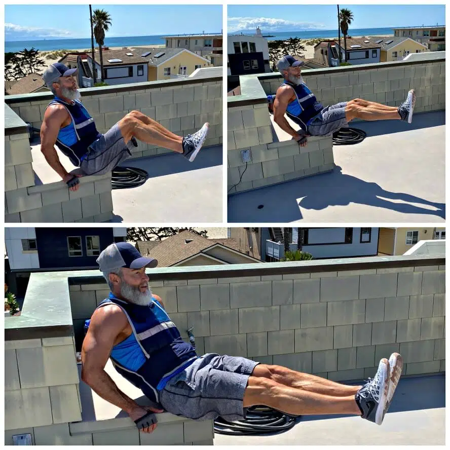 Man doing abdominal exercises outdoors while wearing a fitness vest.