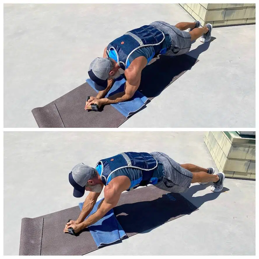 Exerciser trains his triceps and chest muscles while wearing a weighted vest.