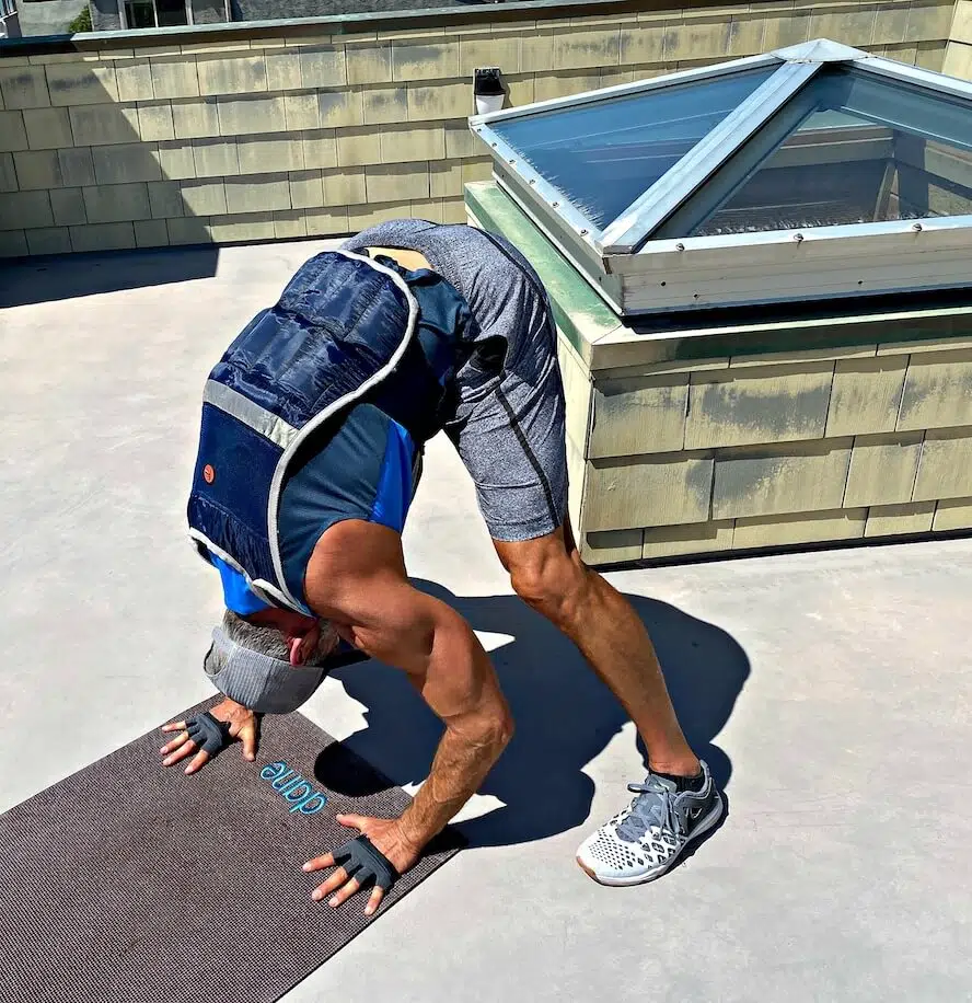Dane Findley, age 54, does tricep bent-over handstand pushups.