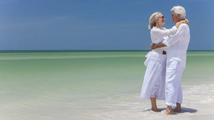 couple at beach being healthy after 60