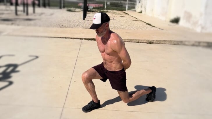 Athlete over the age of 50 doing a legs and thigh workout outdoors.