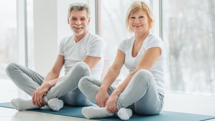 mature couple discovering healthier longevity secrets through yoga